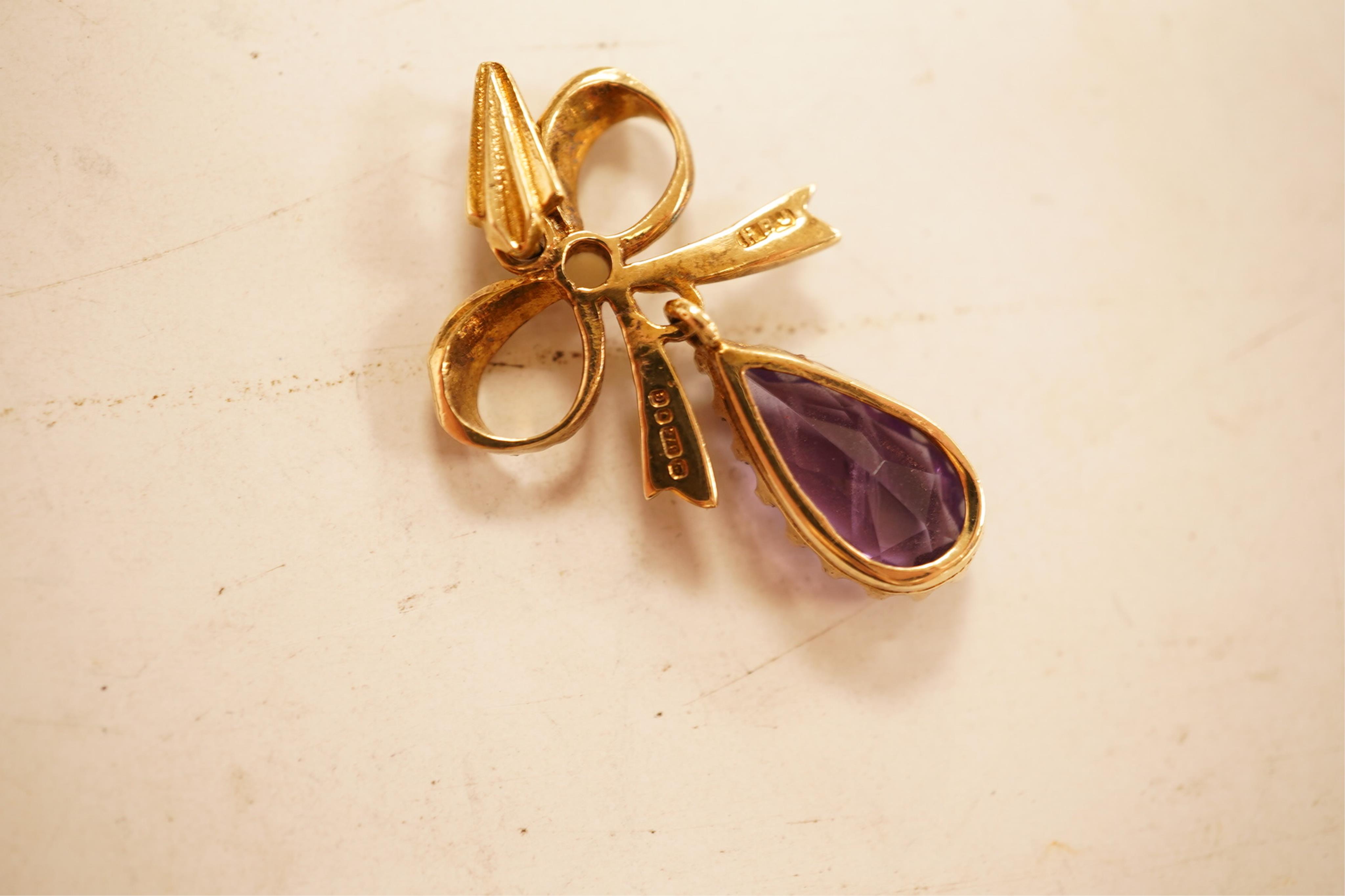 A 1970's 9ct gold, amethyst and seed pearl set drop pendant, 29mm, together with a yellow meta and amethyst set drop pendant.